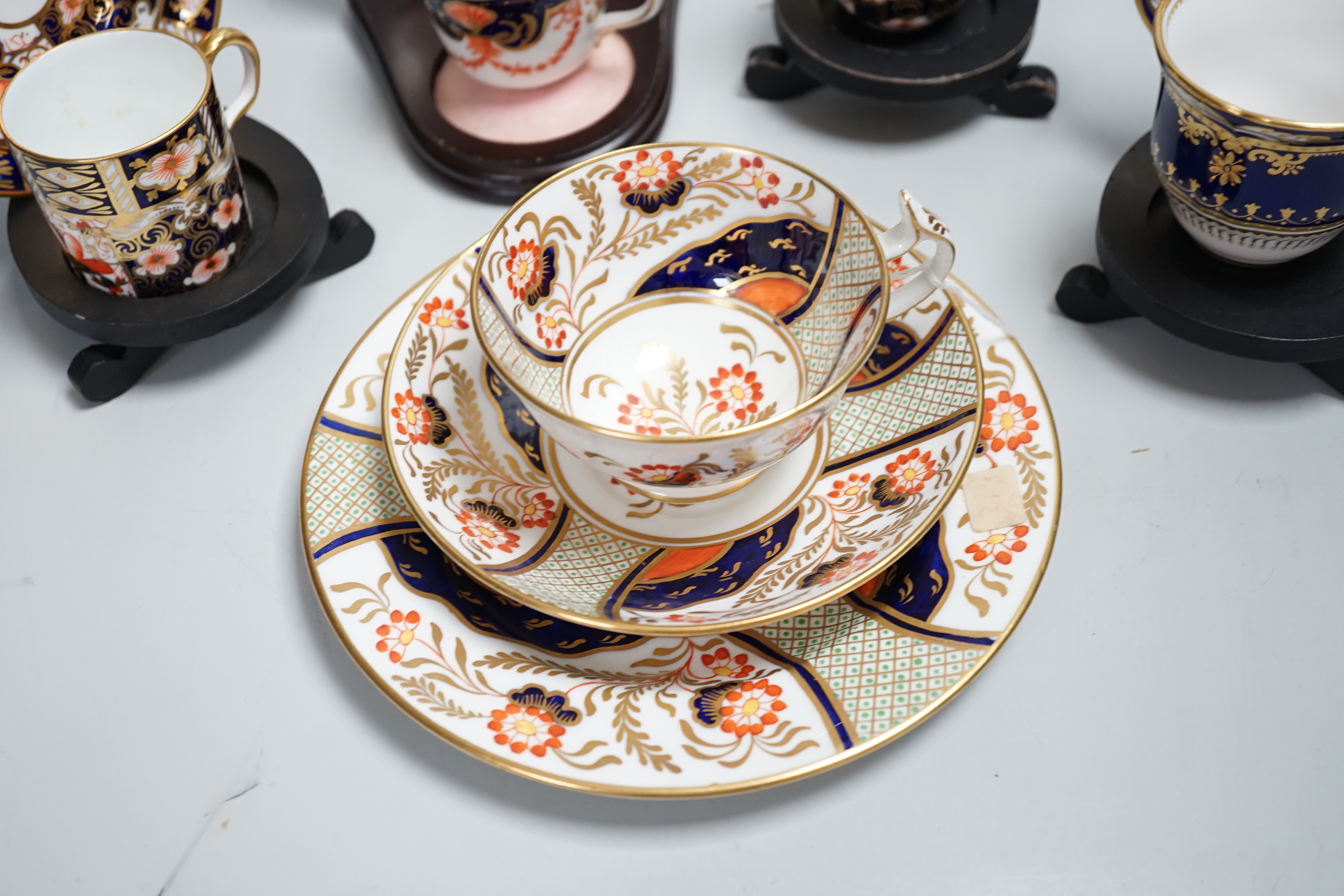 Three pairs of Royal Crown Derby porcelain cups and saucers, another Spode and a Victorian trio